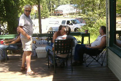 Group of people talking on porch.