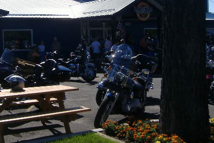 Motorcycles and a park table outside of Lawrence's.