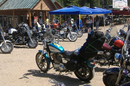 Motorcycles line parking lot outside of event.