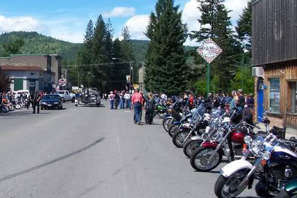 Motorcycles line both sides of the street.