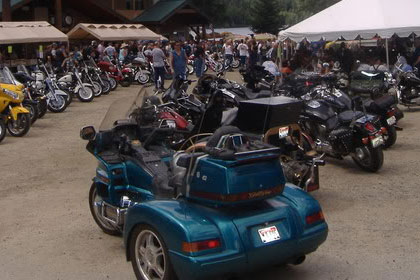 Motorcycles line the parking lot outside of event.