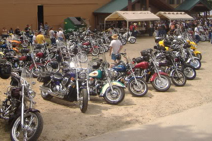 Motorcycles line the parking lot outside of event.
