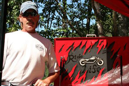 Man poses with red Ride for Life toolbox.