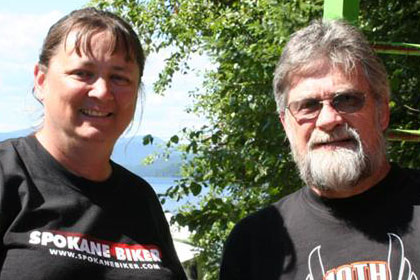 Man and woman pose with wooden box containing a knife.
