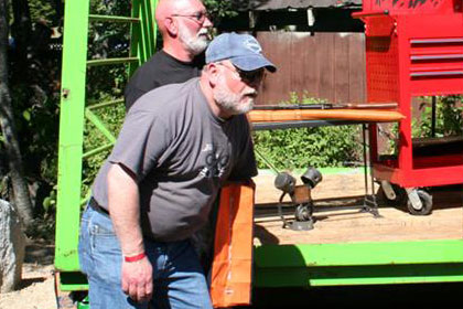 Several men stand around auction stage.
