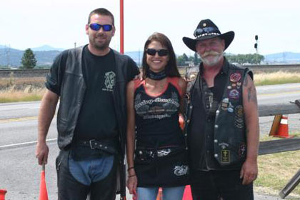 Two men and a woman pose for camera.