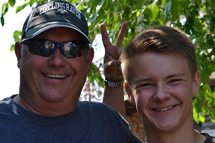 Two guys smile for the camera.