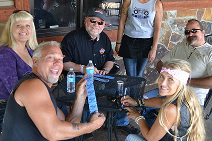 People sitting at a table outside.