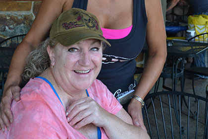 Two women wearing hats smile for the camera.