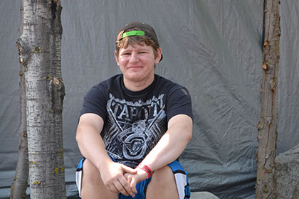 Sitting on a rock outside.