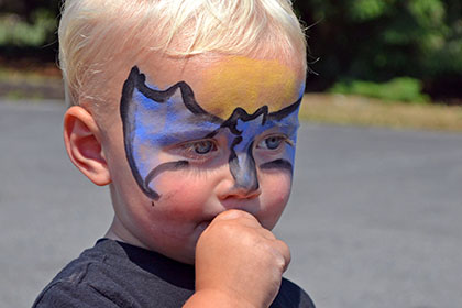 Child with a painted face.