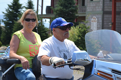 Two riders on a single motorcycle.