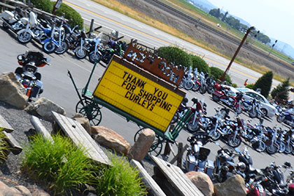 Parking lot filled with motorcycles.