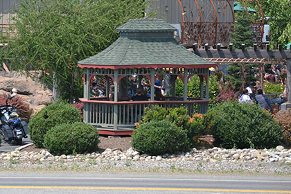 People standing under the gazebo.