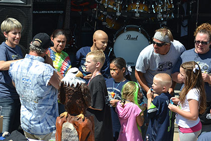 Ride for Life committee members speak with a group of children.