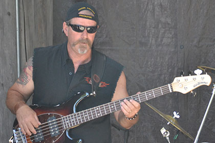 Man playing the guitar on stage.