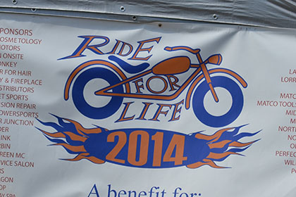 Ride for Life sponsor banner.