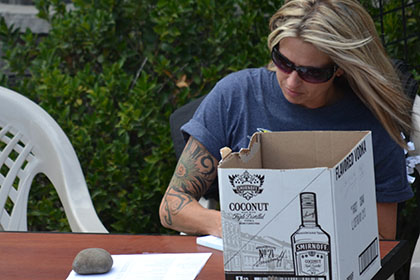 Ride for Life committee member doing paperwork at an outside table.