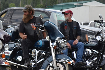 Couple riders sitting on their motorcycles.