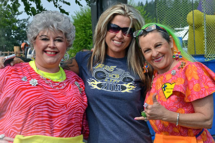 Smiling for the camera in front of the dunk tank and bouncy castle.