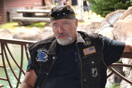 Man relaxing on a bench outside.
