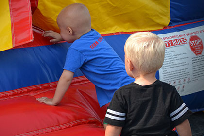 Children climbing into the bouncy castle.