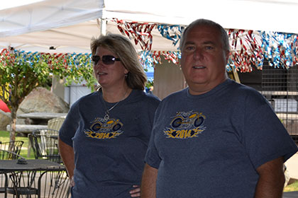 Standing next to an outside table at the Ride for Life event.