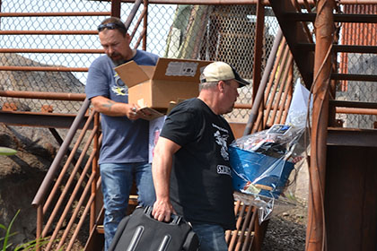 Men carrying boxes.
