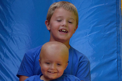 Two children go down the slide together.
