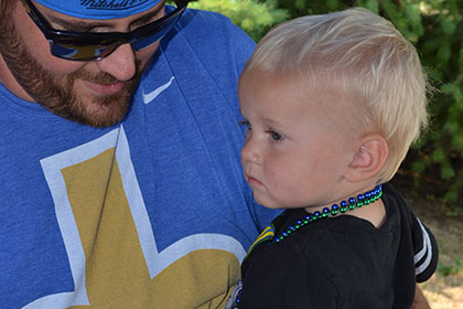 Man holding child at the event.