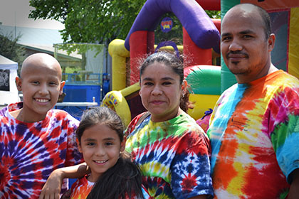 Smiling for the camera in front of the bouncy castle.