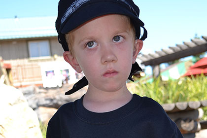 Child wearing a hat at the event.