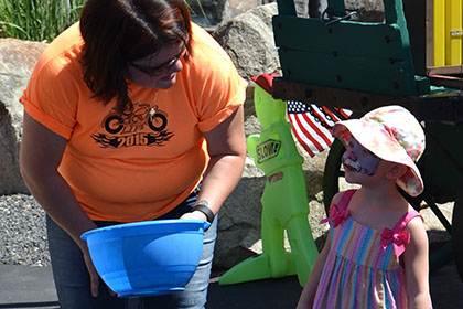 A Ride for Life volunteer speaking with a child.