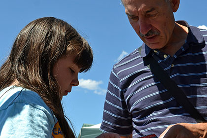 A man helping a young girl.