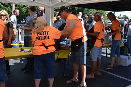 Ride for Life volunteers serving barbecue food at the event.