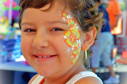 Child with their face painted.