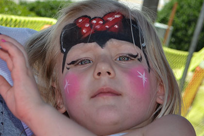 Woman and a child with a painted face.