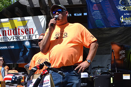 Ride for Life volunteer speaking on the microphone.