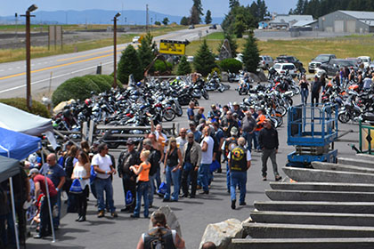 People form a line to get their barbecue food.