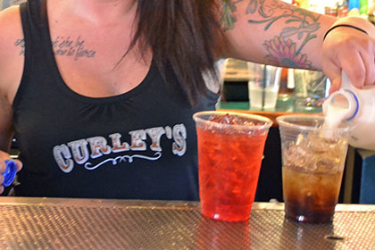 A woman pouring drinks.