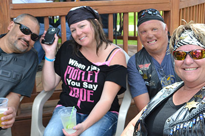 Group of four people smile for the camera.