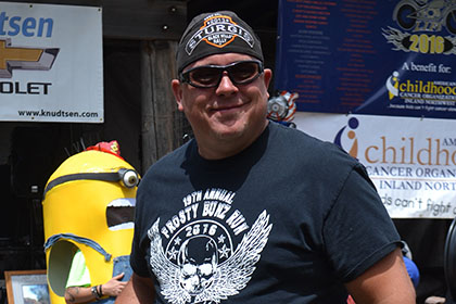 Man with Sturgis bandana and sunglasses, holds his plaque.