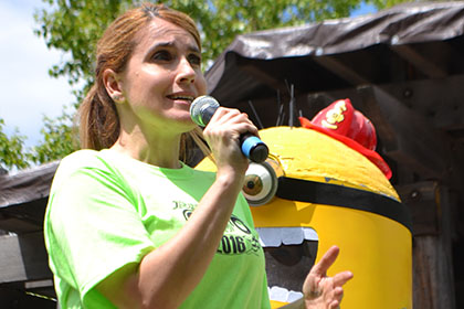 Ride for Life committee member speaking on a microphone.