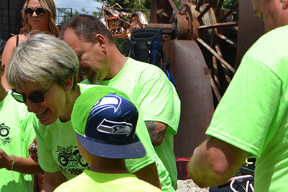 Child wearing a Seattle Seahawks hat with some Ride for Life committee members.