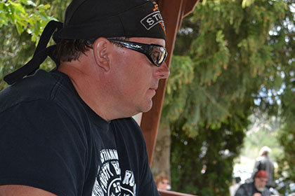 Couple guys sitting at an outside table.