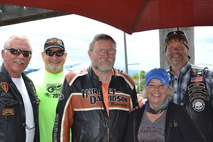 Five people pose for a photo at the event.