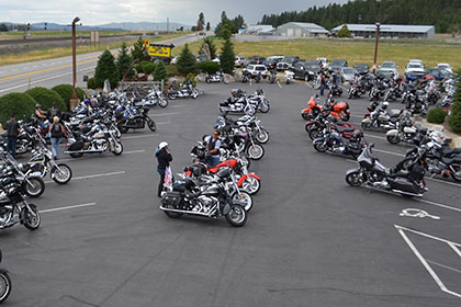 Motorcycles and vehicles in the parking lot.