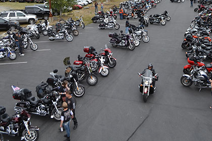 Rows of motorcycles in the parking lot.
