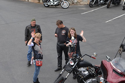 People in the parking lot waving at the camera.