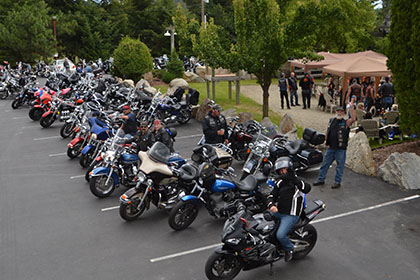 Motorcycles lined up in the parking lot.